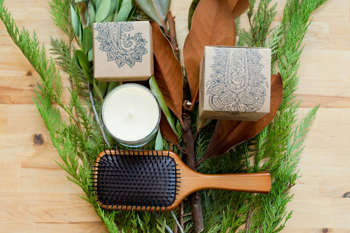 amla methi hair conditioning bar resting on a bamboo dish beside fresh amla and fenugreek seeds
